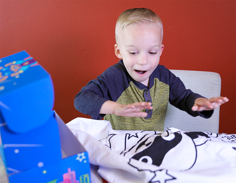 Boy Surprised By Superhero Box