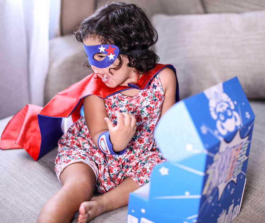 Girl Opening Superhero Box