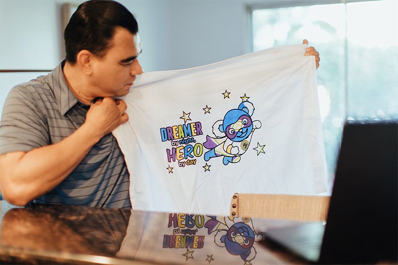 original_images/man-holding-decorated-superhero-pillowcase.jpg
